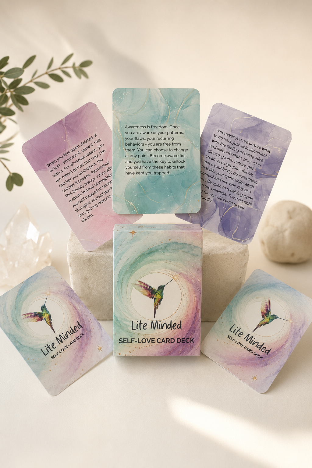 Self-Love affirmation card deck box standing with cards fanned out and a trailing plant