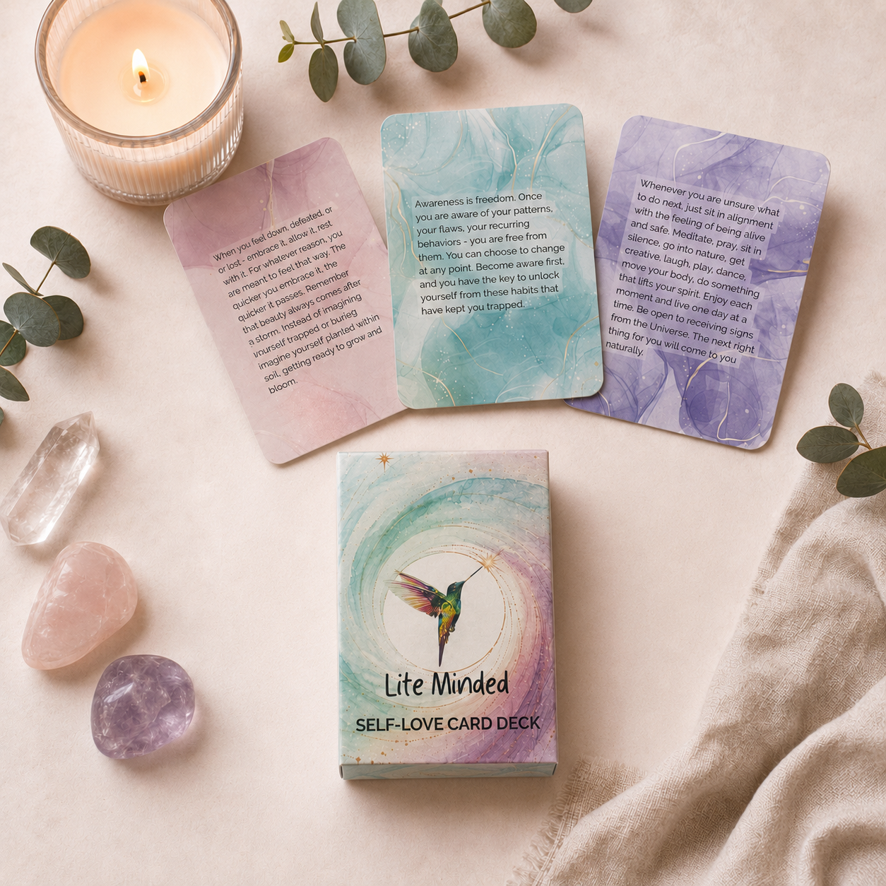 Self-Love affirmation card deck and fanned cards styled with healing crystals and eucalyptus